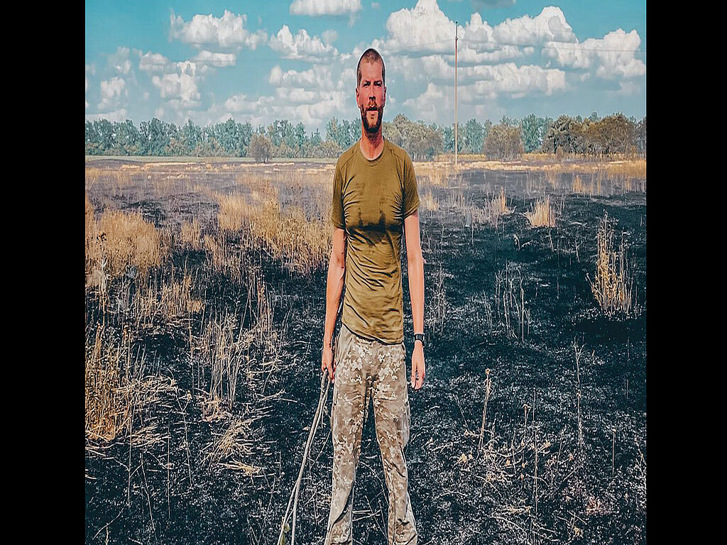 Oleksiy and the burnt field after the Russian attacks