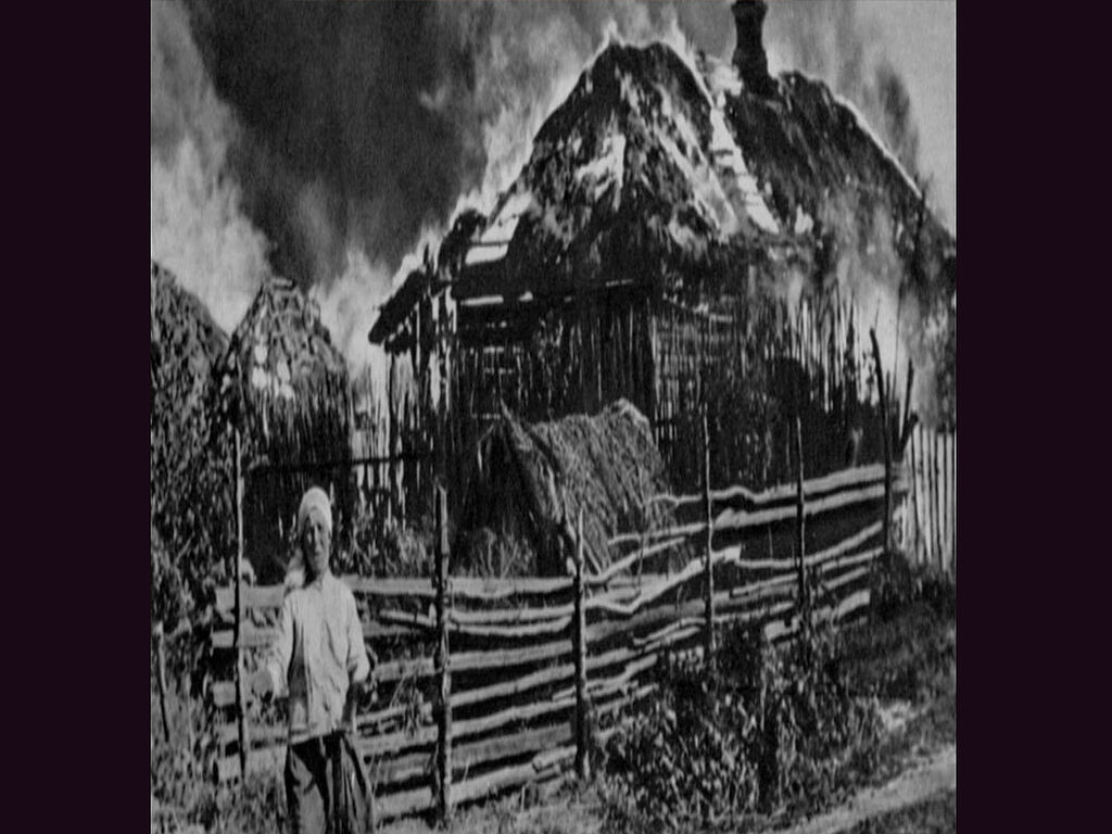 A Soviet woman cries near her burnt house