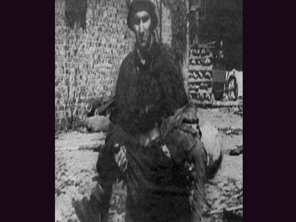 A soldier carrying a child during the Warsaw Uprising