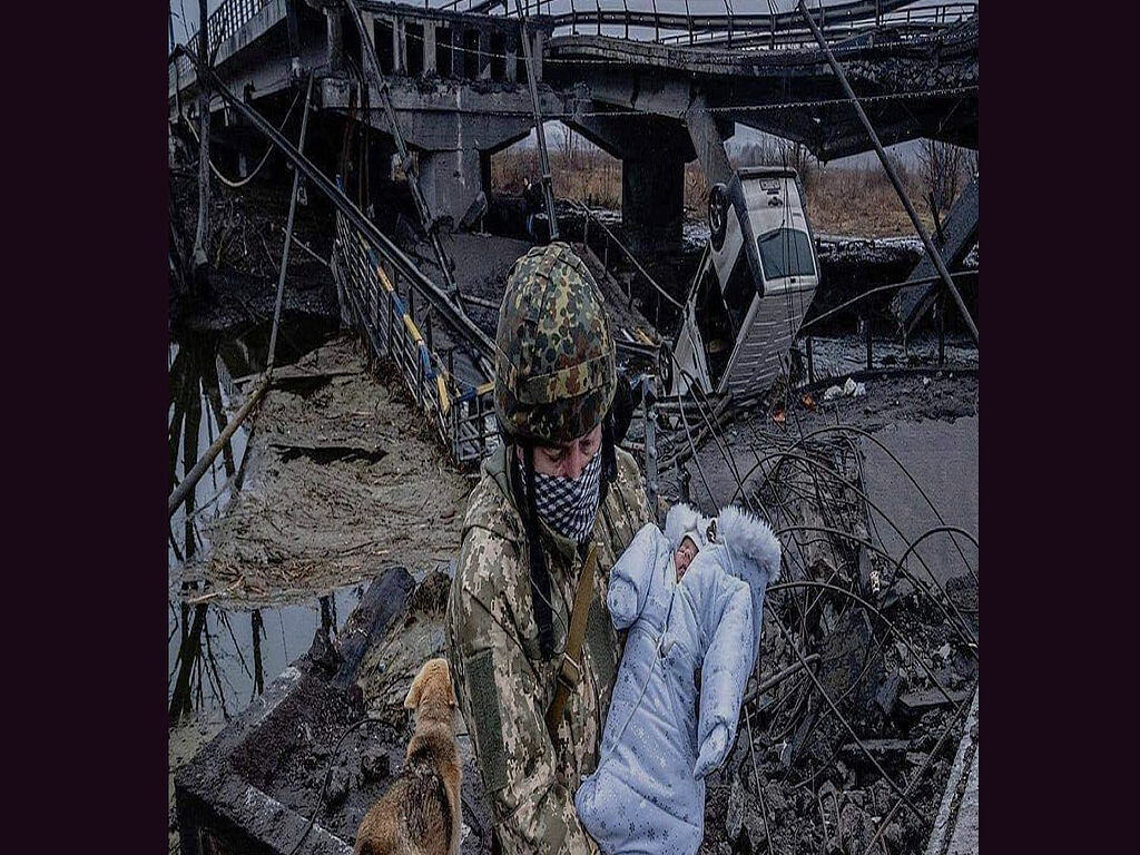 Ukrainian soldier carries a child across a destroyed bridge