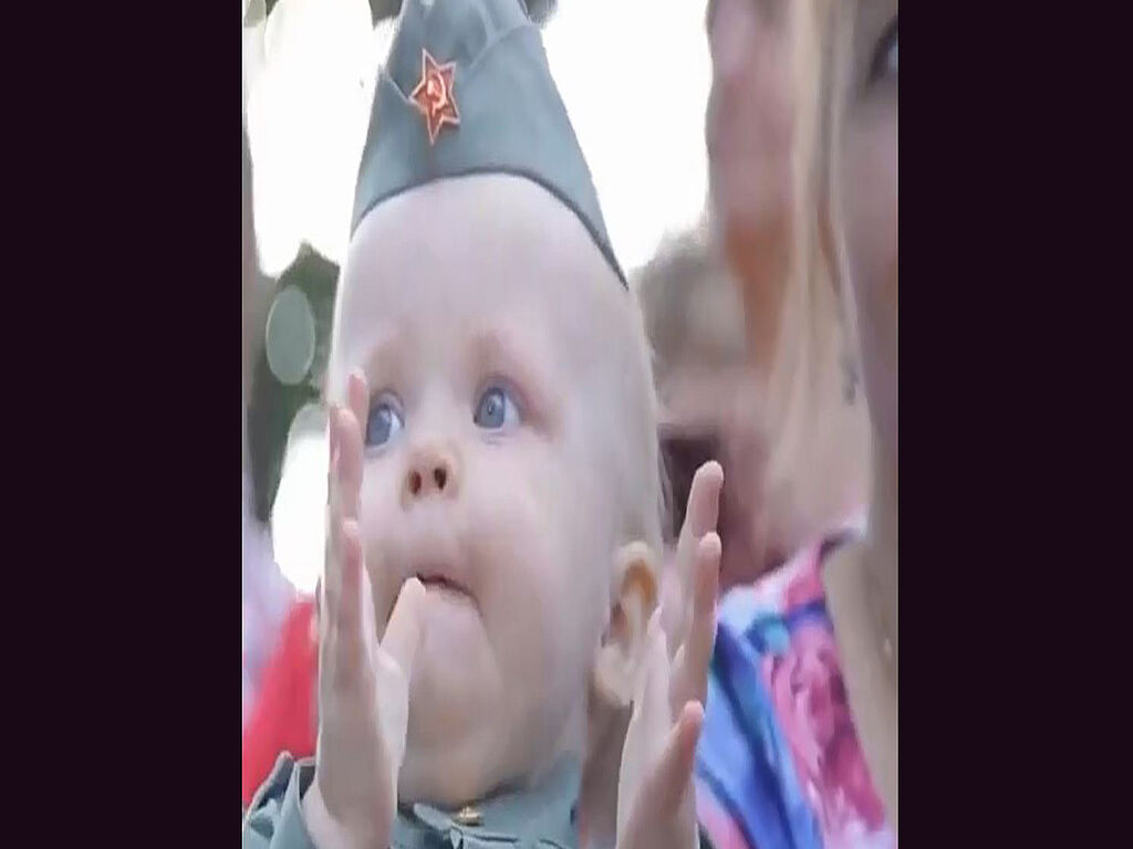 A child in a soldier's cap