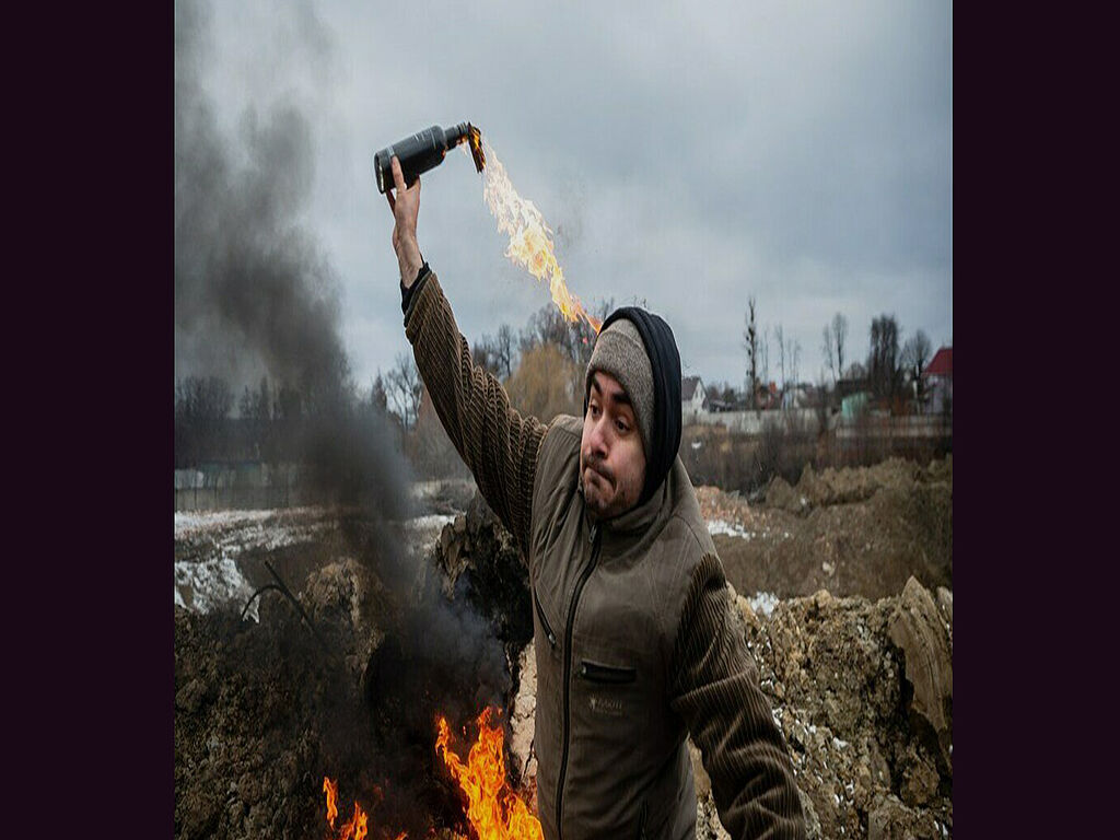 A Ukrainian throws a molotov cocktail at Russian occupiers