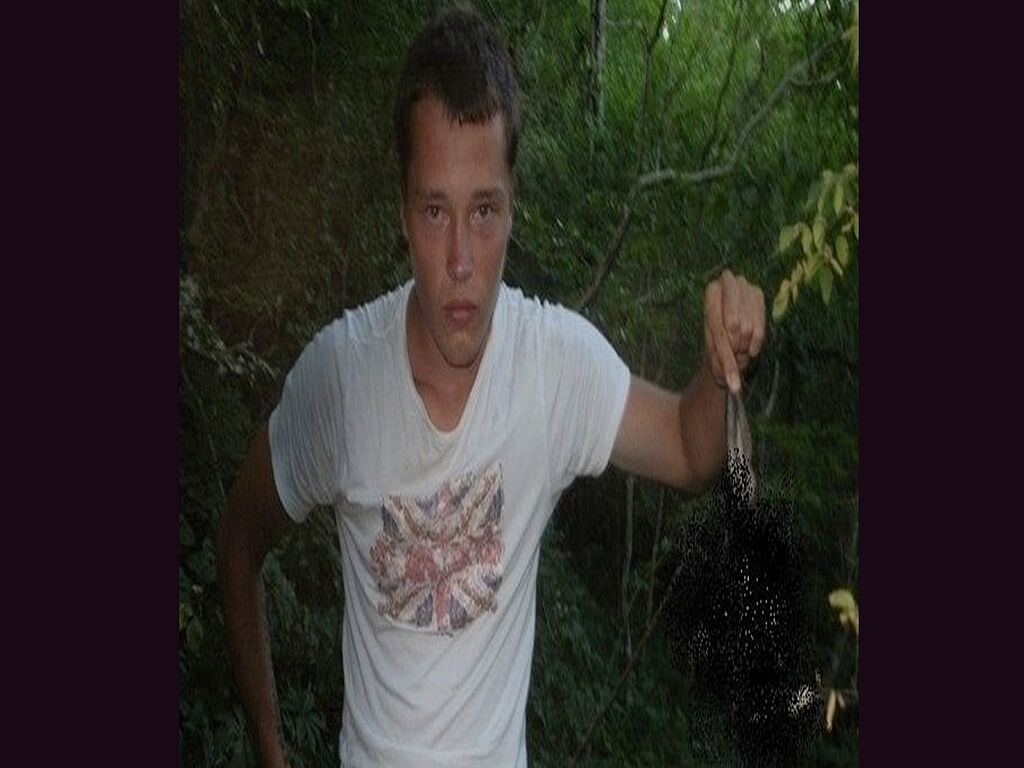 Photo from childhood, Oleksiy holding a killed animal