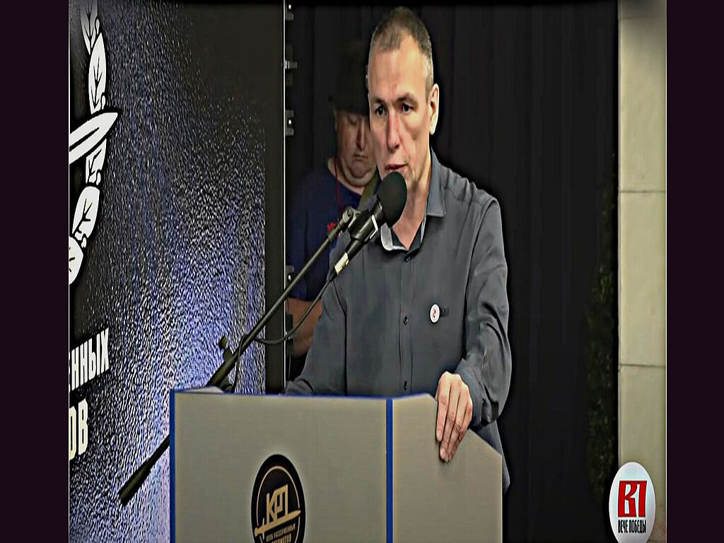 Maxim Klimov speaks on stage on behalf of the club of angry patriots