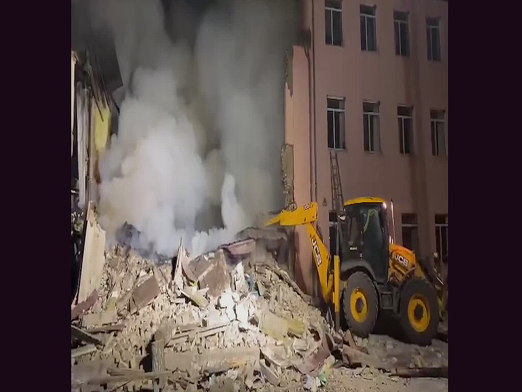 Technicians and rescuers removing the rubble